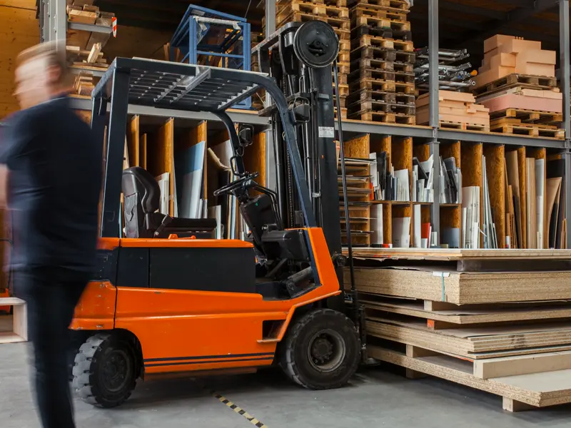 Electric forklift truck in a warehouse, Barns Industrial Battery Services Essex